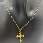 Fotografía real del Collar Bruma sobre busto negro, con cuentas de cuarzo ahumado, cadena dorada tipo rosario y colgante de cruz dorada.