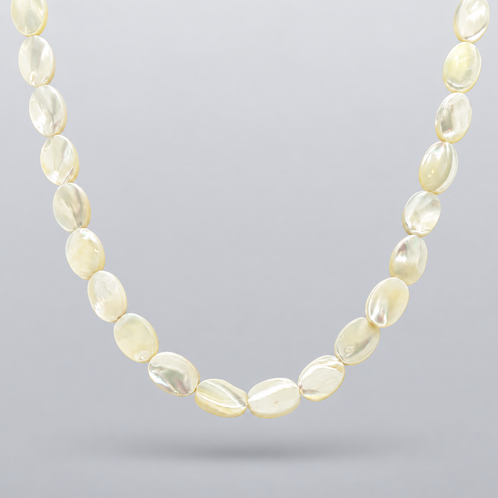 Collar Nácar de cuentas ovaladas de nácar natural, suspendido sobre fondo gris claro en degradado con una sombra suave.